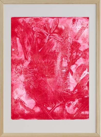 Framed artwork with a red abstract design on a white background