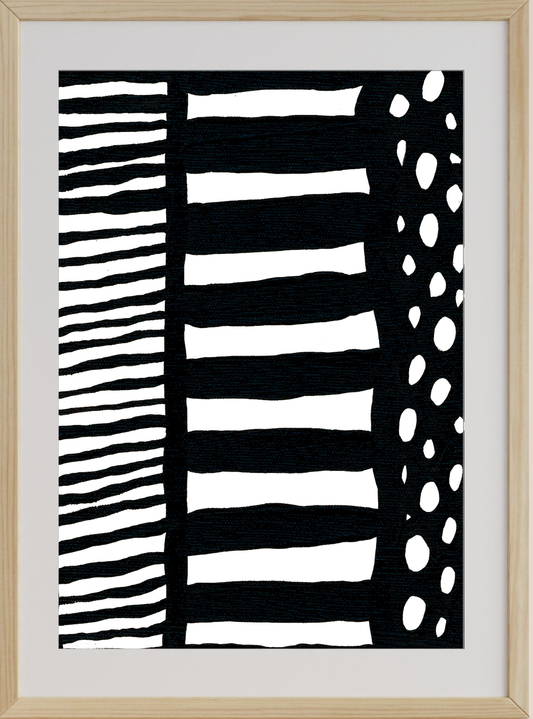 Abstract black and white artwork with striped and dot patterns in a wooden frame.