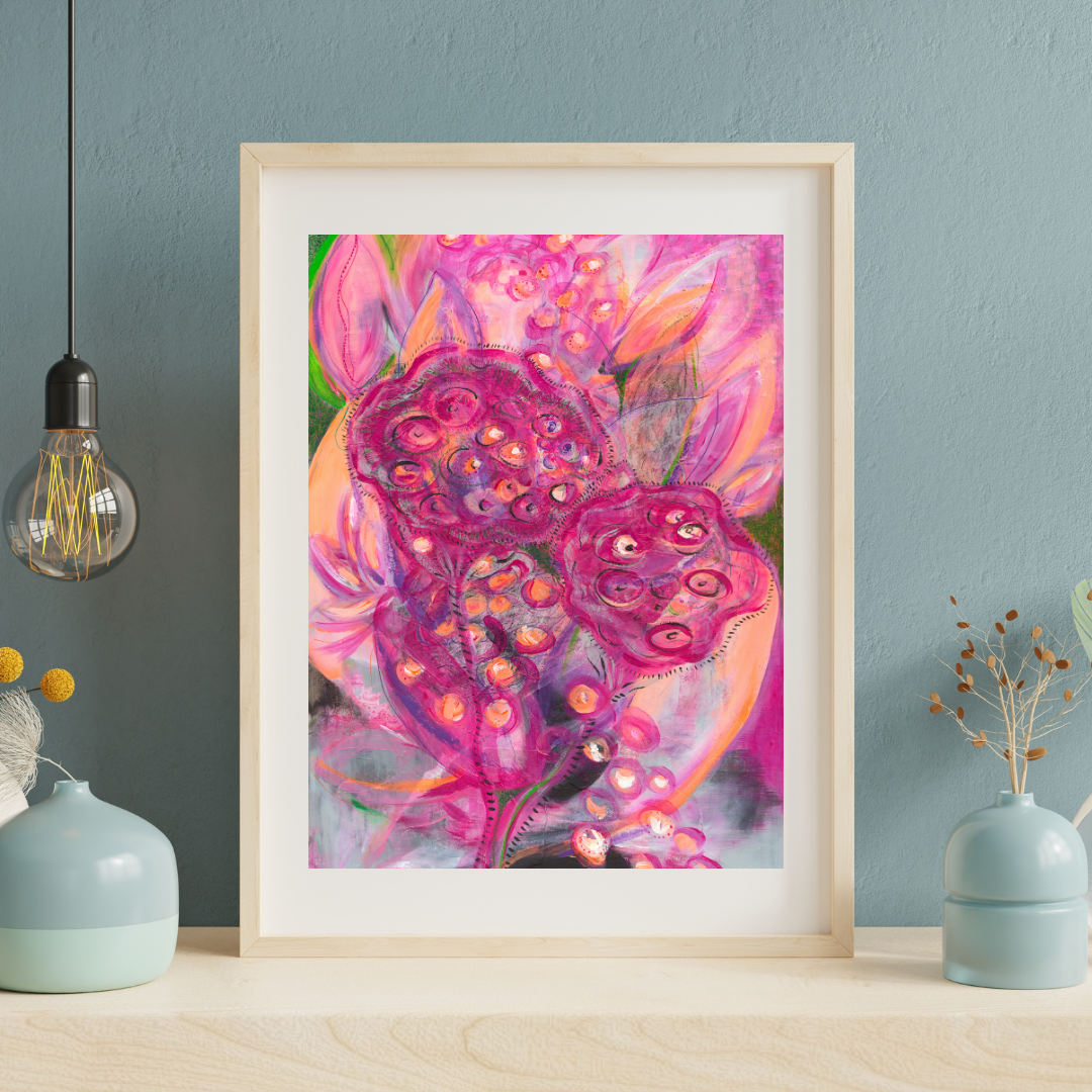 Framed colorful floral artwork on a wall with decorative vases and a light bulb.