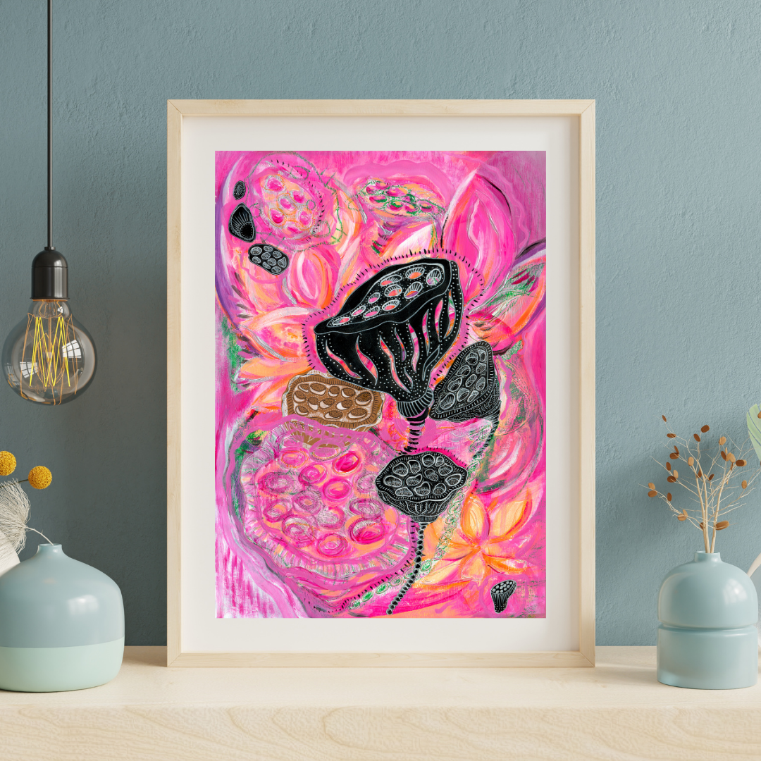 Framed abstract artwork with pink and black design on a blue wall.