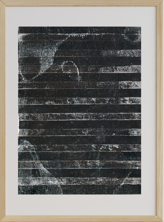 Abstract black and white artwork in a wooden frame