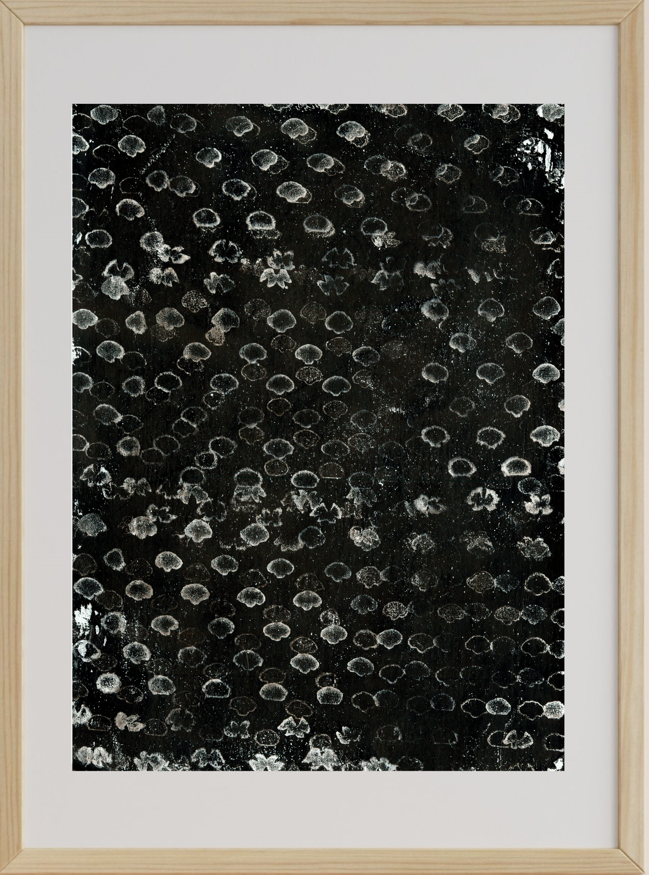 Framed abstract art with black and white pattern on a white background