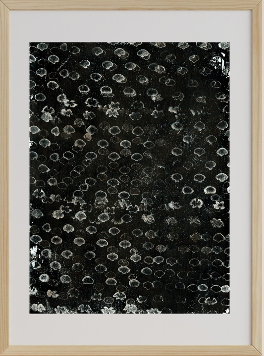 Framed abstract art with black and white pattern on a white background
