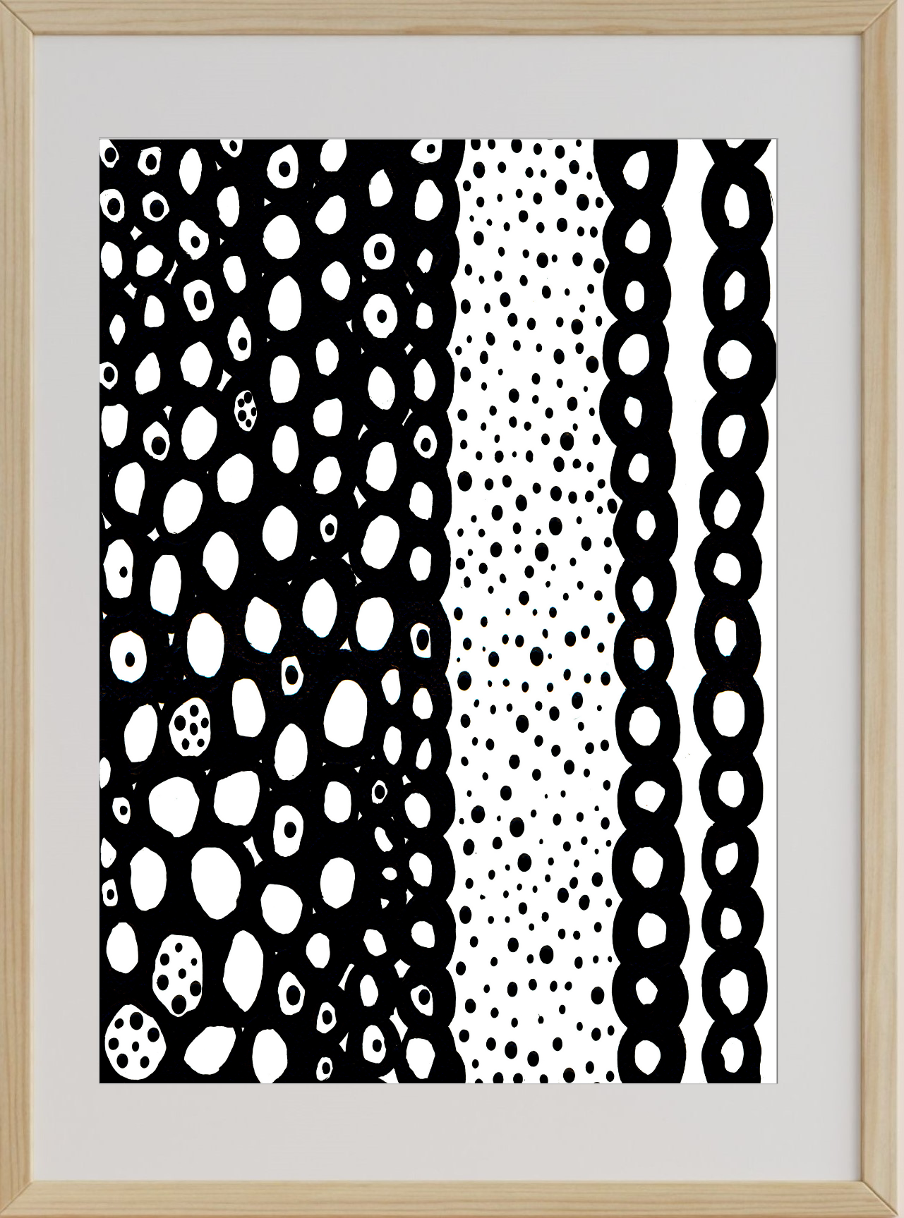 Framed artwork with black and white abstract patterns on a light wood frame.